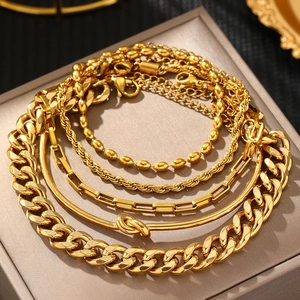 Five-piece gold stainless steel bracelet set with curb chain and snake bone layers