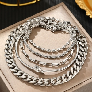 Five-piece silver stainless steel layered bracelet set with Cuban link and snake chain styles