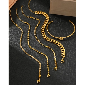 Five-piece gold stainless steel jewelry set with Cuban curb chains and knotted bangle