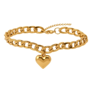 Detail of golden heart pendant on chunky Cuban chain anklet with lobster clasp closure