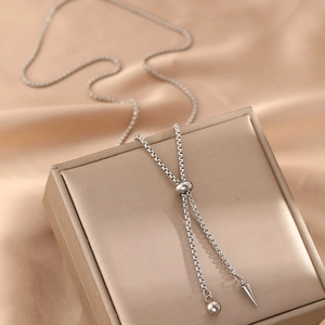Silver stainless steel Y-shaped cone pendant necklace on elegant satin background