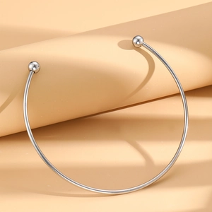 Minimalist stainless steel collar necklace with silver beads in elegant striped sunlight