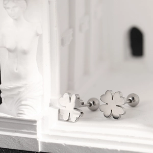 Close-up of polished silver clover stud earrings with secure barbell screw back closure