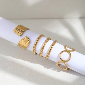 Set of gold stainless steel rings featuring vintage hammered and twisted band designs
