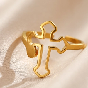 Adjustable hollow cross ring in polished gold stainless steel on champagne silk background