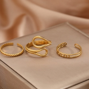 Three-piece set of vintage gold hollow adjustable rings on champagne silk fabric