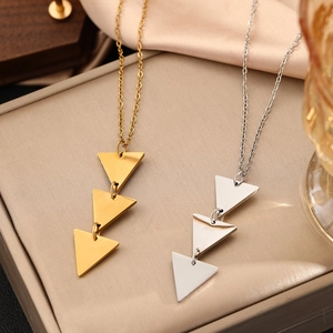 Long chain necklace with triple polished metal triangle pendants in gold and silver