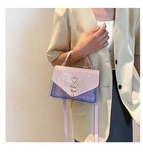 Detail of pink sequin flap with gold tassel and purple transparent PVC shoulder bag