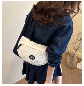 Rear view of a model wearing a white crescent nylon bag with lucky fashion logo