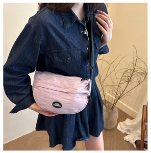 Detail of light purple nylon crescent bag with adjustable strap and Lucky Fashion label