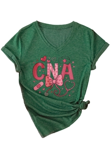 Close-up of pink CNA heart medical icons on dark green V-neck short sleeve shirt