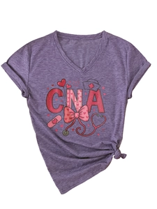 Detail of purple V-neck CNA t-shirt with nursing icons and heart graphics on plain background