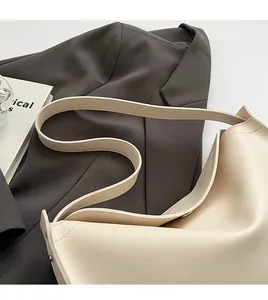 Detail of creamy white leather tote bag featuring a wide comfortable shoulder strap