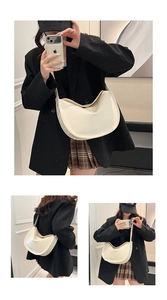Detail view of cream white hobo tote bag featuring minimalist leather texture and wide strap