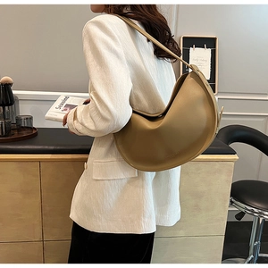 Detailed side view of the khaki half-moon tote bag with minimalist lines and smooth texture