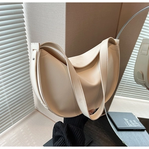 Minimalist cream white crescent shoulder bag with soft leather texture and wide strap