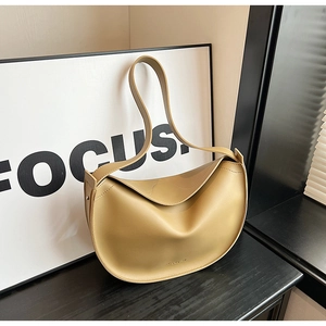Detail view of khaki hobo bag with smooth matte leather texture and minimal embossed text