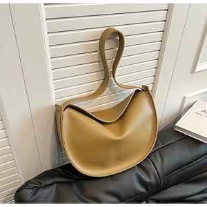 Detailed macro view of khaki leather crescent bag with minimalist embossed logo branding