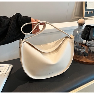 Close-up of cream leather hobo bag featuring debossed logo and smooth matte finish