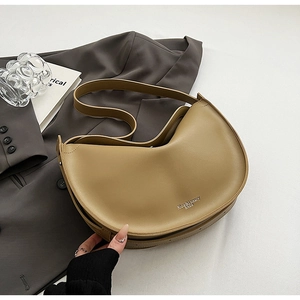 Detail of khaki crescent tote bag with Rioa & Luxury branding on smooth faux leather