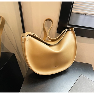 Detailed view of mustard yellow half-moon tote bag with Nice & Lucky embossed logo