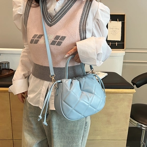 Light blue quilted faux leather crossbody bag with rhombic pattern and drawstring detail