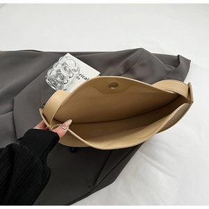 Internal view of beige leather tote bag showing magnetic closure and spacious compartment