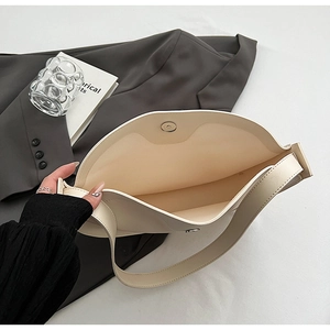 Detailed interior of minimalist beige tote bag showing large capacity and magnetic closure