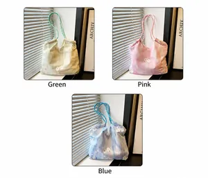 Three tie-dye tote bags in green, pink, and blue with 3D white floral embroidery