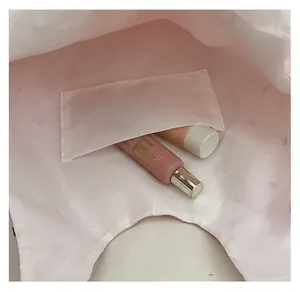 Detailed view of the internal slip pocket showing storage capacity for cosmetics