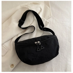 Detail of black nylon crossbody bag with double zippers and unique triangle pulls