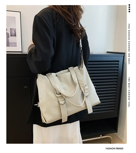 Detailed view of cream PU leather tote bag with silver buckle and soft texture on shoulder