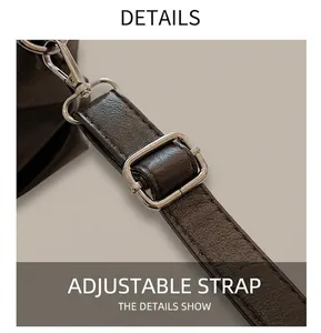 Detail of adjustable dark brown faux leather shoulder strap with silver metal buckle