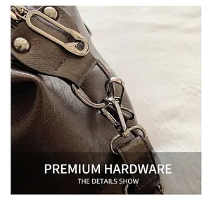 Detail showing dark brown lychee grain leather with gunmetal pin and buckle hardware