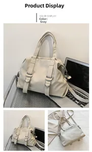 Detail view of grey large tote bag showing soft faux leather and silver buckle hardware