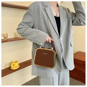 Brown geometric octagonal box bag with gold metal frame and woven handle details