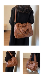 Detail view of large brown retro faux leather tote bag with multiple pockets and straps