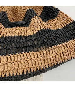 Detailed close-up showing the 3D woven texture and black and brown striped straw pattern