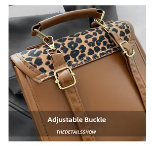 Close-up of the adjustable metal buckle on a brown leopard print leather backpack