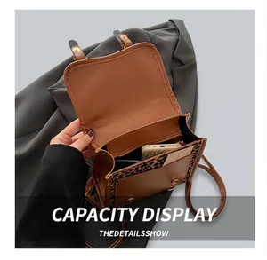 Interior view showing capacity of leopard print bag with compartments for essentials