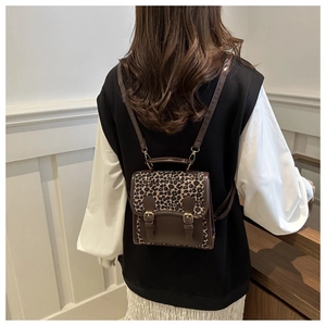 Detail of leopard print mini backpack with vintage buckles and detachable shoulder strap