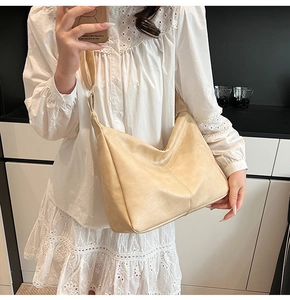Mirror selfie showing the large beige PU leather hobo bag on a model for scale