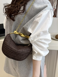 Brown woven half-moon straw handbag with a gold metal handle and chain strap