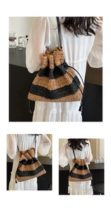 Detail of striped straw bucket bag with drawstring closure and black shoulder strap