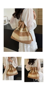 Detail view of striped woven straw bucket bag with drawstring closure and leather strap