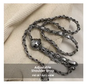 Detail of silver metal chain strap with adjustable quilted ball buckle for handbags