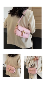 Detail showing pink saddle bag with golden horseshoe buckle and adjustable leather strap