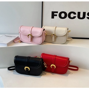 Detail of four colorful crossbody bags with elegant gold C-shaped metal buckles