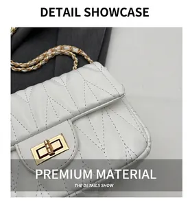 Macro shot of white quilted crossbody bag with golden twist lock and textured leather