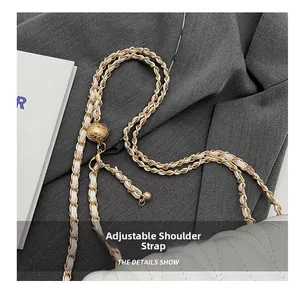Detail of adjustable gold chain strap with metallic ball buckle on white quilted bag